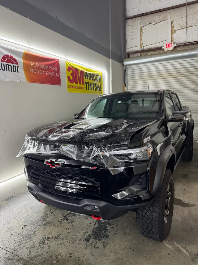 Black Chevrolet Colorado ZR2 having paint protection film fitted to the hood and front end in Alpharetta, GA