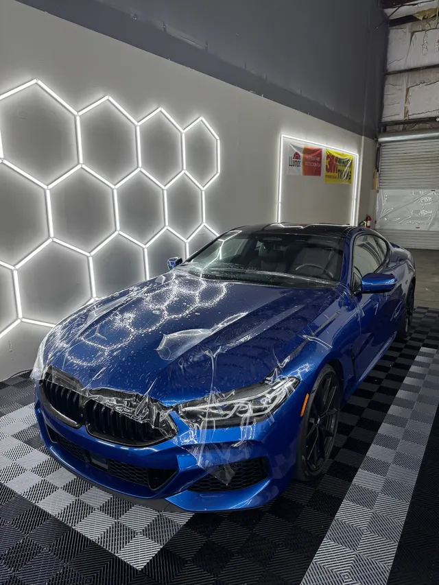 Blue BMW coupe having paint protection film fitted to the hood and front bumper in Alpharetta, GA