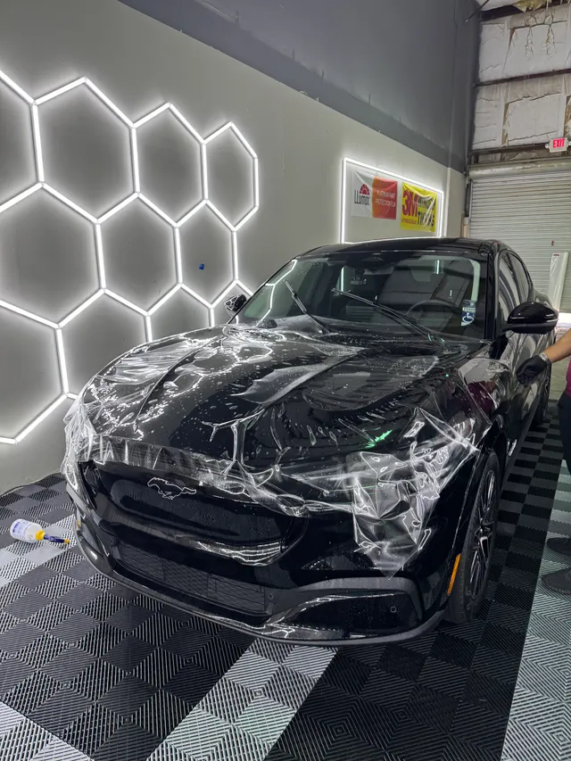 Black BMW coupe having paint protection film worked into the hood and fenders in Alpharetta, GA