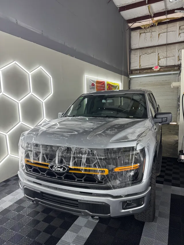 Silver Ford F-150 having paint protection film fitted to the hood and front bumper in Alpharetta, GA