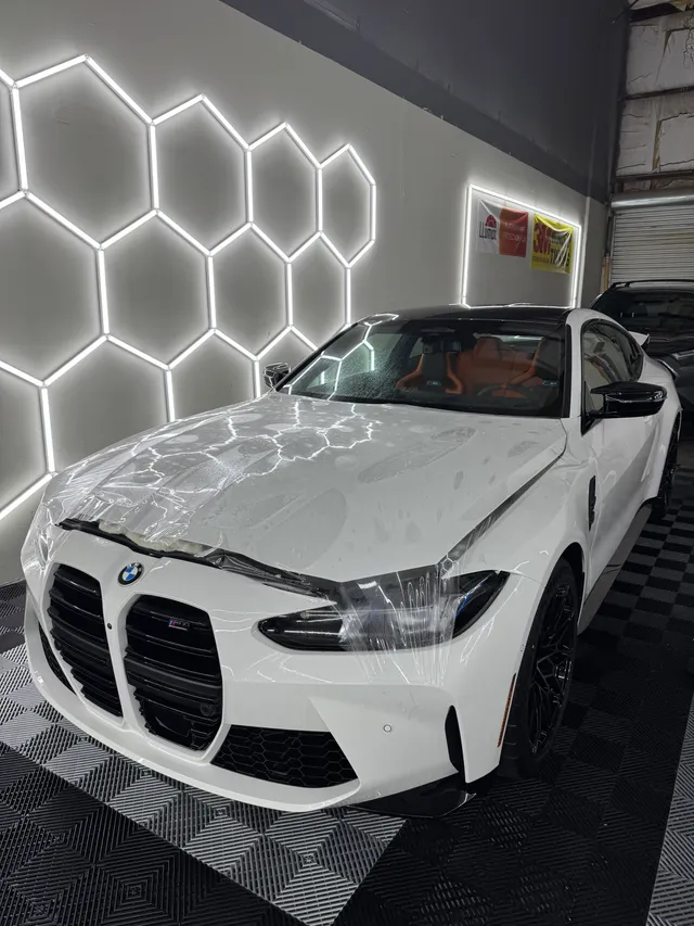 White BMW M4 having paint protection film fitted to the hood and front end in Alpharetta, GA