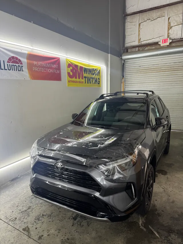 Grey Toyota RAV4 having paint protection film fitted to the hood and front bumper in Alpharetta, GA
