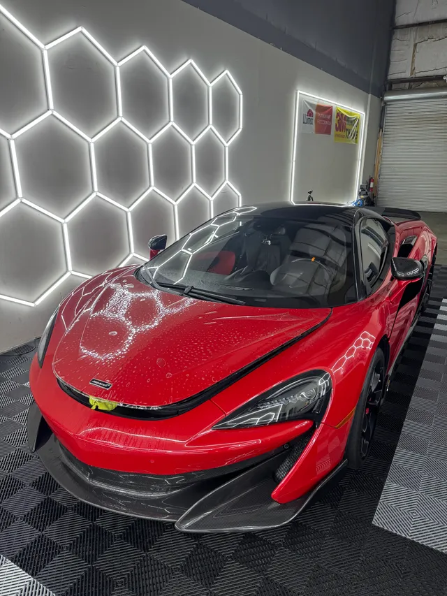 Red McLaren having paint protection film fitted to the hood, splitter and front end in Alpharetta, GA
