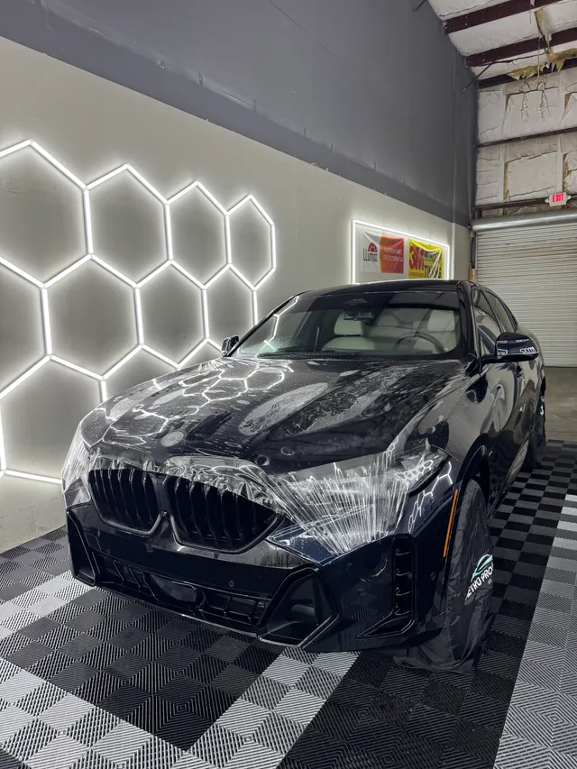 Black BMW SUV coupe having paint protection film fitted to the hood and front end in Alpharetta, GA